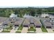 Aerial view of the property and the surrounding community, featuring a serene lake at 281 Villa Corte Dr, Lutz, FL 33549