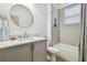 Neutral toned bathroom featuring a round mirror and tiled shower and bath combo at 281 Villa Corte Dr, Lutz, FL 33549