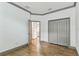 Bedroom with wood-look tile, white walls, grey trim, large closet and view to bathroom at 281 Villa Corte Dr, Lutz, FL 33549