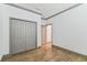 Empty bedroom featuring wood-look tile flooring, white walls, grey trim, and large closet at 281 Villa Corte Dr, Lutz, FL 33549