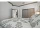 Bedroom view to bathroom features decorative bed, large closet, wood-look tile, crown molding, and paint at 281 Villa Corte Dr, Lutz, FL 33549