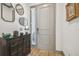 Inviting entryway featuring a stylish dresser, decorative mirrors, and a charming table lamp at 281 Villa Corte Dr, Lutz, FL 33549
