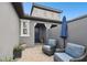 Charming front patio featuring stylish outdoor seating, privacy walls, and a welcoming entrance to the home at 281 Villa Corte Dr, Lutz, FL 33549