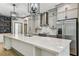Bright kitchen with a large island, stainless steel appliances, and modern lighting fixtures at 281 Villa Corte Dr, Lutz, FL 33549
