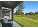 Inviting covered patio with outdoor seating overlooking a tranquil pond at 281 Villa Corte Dr, Lutz, FL 33549