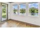 Serene room with large windows overlooking a picturesque lake and lush greenery at 281 Villa Corte Dr, Lutz, FL 33549