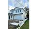 White two-story home featuring an attached two car garage and a white picket fence at 318 W Park Ave, Tampa, FL 33602