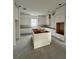 Unfinished kitchen featuring white cabinets and a center island with wood detailing at 318 W Park Ave, Tampa, FL 33602