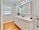 Elegant bathroom with white vanity, quartz countertop, and hardwood floors at 34902 Greensteele Rd, Dade City, FL 33525