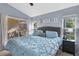 A soothing bedroom with blue bedding, natural light, and views of the backyard, promoting tranquility at 4474 Connery Ct, Palm Harbor, FL 34685