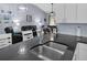 Spacious kitchen featuring a stainless steel sink, granite countertops, and open layout, great for entertaining guests at 4474 Connery Ct, Palm Harbor, FL 34685