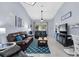 Bright and inviting living room with tile flooring, vaulted ceiling, and comfortable leather seating for relaxation at 4474 Connery Ct, Palm Harbor, FL 34685