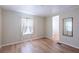 Bright bedroom with wood-look flooring and access to bath at 7154 El Meyers St, Zephyrhills, FL 33541