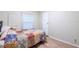 Bedroom with a floral quilt on the bed at 7154 El Meyers St, Zephyrhills, FL 33541