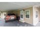 Tan mobile home with carport at 7154 El Meyers St, Zephyrhills, FL 33541