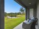 Relaxing patio with lake view and wicker chairs at 281 Villa Corte Dr, Lutz, FL 33549
