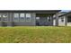 Private backyard with covered patio and grassy area at 281 Villa Corte Dr, Lutz, FL 33549