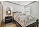 Bright bedroom with wood floors, a double door closet, and a window with blinds at 281 Villa Corte Dr, Lutz, FL 33549