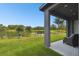 Relaxing covered patio overlooking a serene lake at 281 Villa Corte Dr, Lutz, FL 33549