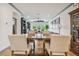 Bright dining room with wooden table and chairs, view to living room at 281 Villa Corte Dr, Lutz, FL 33549