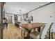 Open kitchen with island, stainless steel appliances, and wooden dining table at 281 Villa Corte Dr, Lutz, FL 33549