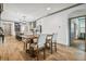 Open kitchen with island, stainless steel appliances, and wooden dining table at 281 Villa Corte Dr, Lutz, FL 33549