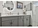 Modern bathroom with gray vanity, frameless shower, and hexagon floor tiles at 281 Villa Corte Dr, Lutz, FL 33549