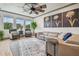 Relaxing living room with a large sectional sofa and ceiling fan at 281 Villa Corte Dr, Lutz, FL 33549