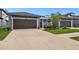 Two-car garage with driveway and landscaping at 281 Villa Corte Dr, Lutz, FL 33549
