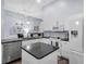 Modern kitchen with white cabinets, granite island, and stainless steel appliances at 4474 Connery Ct, Palm Harbor, FL 34685