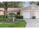 Two-car garage and manicured landscaping at 4474 Connery Ct, Palm Harbor, FL 34685