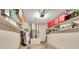 Garage with shelving, water heater, and plenty of storage at 4474 Connery Ct, Palm Harbor, FL 34685