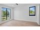 Bedroom with a large window, light wood floors, and white walls showcasing natural light at 2203 Glenwood, Tampa, FL 33602