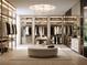 Luxurious walk-in closet with custom shelving, ample storage, a large round settee, and elegant lighting fixtures at 2203 Glenwood, Tampa, FL 33602