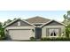 One-story home with gray siding, a two-car garage, and landscaping at 10943 Gentle Current Way, Parrish, FL 34219