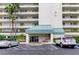 Condo building entrance with teal awning and parking at 7922 Sailboat Key S Blvd # 607, South Pasadena, FL 33707