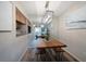 Dining room with wood table, bench seating, and a stylish light fixture at 2935 Lichen Ln # C, Clearwater, FL 33760
