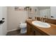 Clean bathroom with wood vanity, toilet, and updated fixtures at 2935 Lichen Ln # C, Clearwater, FL 33760