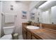 Clean bathroom with wood vanity, updated fixtures, and a shower/tub combo at 2935 Lichen Ln # C, Clearwater, FL 33760