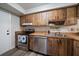 Kitchen with wood cabinets, stainless steel appliances, and double sink at 2935 Lichen Ln # C, Clearwater, FL 33760