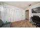 Bedroom with a gray sofa, built-in closet, and home office at 2935 Lichen Ln # C, Clearwater, FL 33760