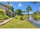 House exterior showcasing a screened porch and pond view at 87 1St Nw Ave, Lutz, FL 33548