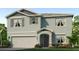 Two story home with light blue exterior and a two car garage at 18319 Wheathouse Pl, Lakewood Ranch, FL 34211