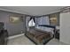 Spacious bedroom with a king-size bed and gray accent wall at 29129 S Bay Hollow S Dr # 3213, Wesley Chapel, FL 33543