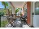 Cozy balcony with outdoor seating and views of lush tropical foliage at 201 6Th S St # 106, St Petersburg, FL 33701