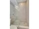 Modern tiled shower with glass enclosure and river rock floor at 201 6Th S St # 106, St Petersburg, FL 33701