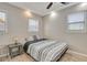 Cozy bedroom with ceiling fan, windows, and a stylish patterned bedding at 201 6Th S St # 106, St Petersburg, FL 33701