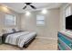 Cozy bedroom featuring a ceiling fan and two windows with natural light at 201 6Th S St # 106, St Petersburg, FL 33701