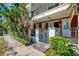 Apartment building exterior featuring lush landscaping and private entrances at 201 6Th S St # 106, St Petersburg, FL 33701