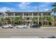 Street view of modern apartment building with balconies and tropical landscaping at 201 6Th S St # 106, St Petersburg, FL 33701
